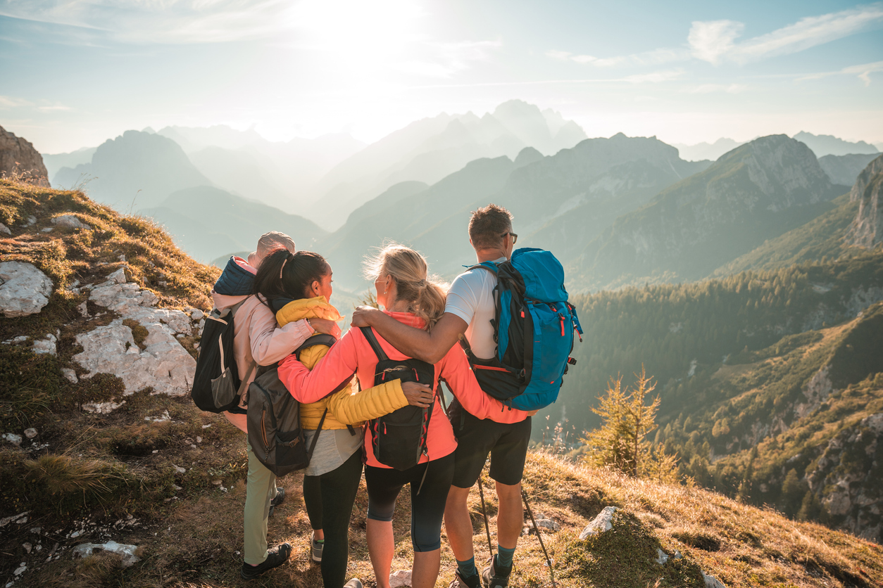 People enjoying outdoor recreation activities in nature with mountains in background