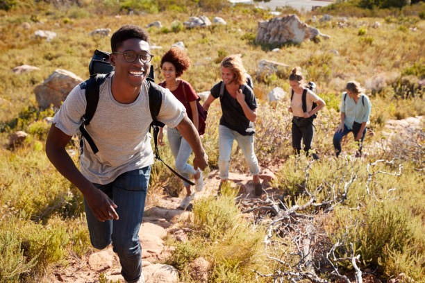 Diverse group of people enjoying outdoor recreational activity together in park setting